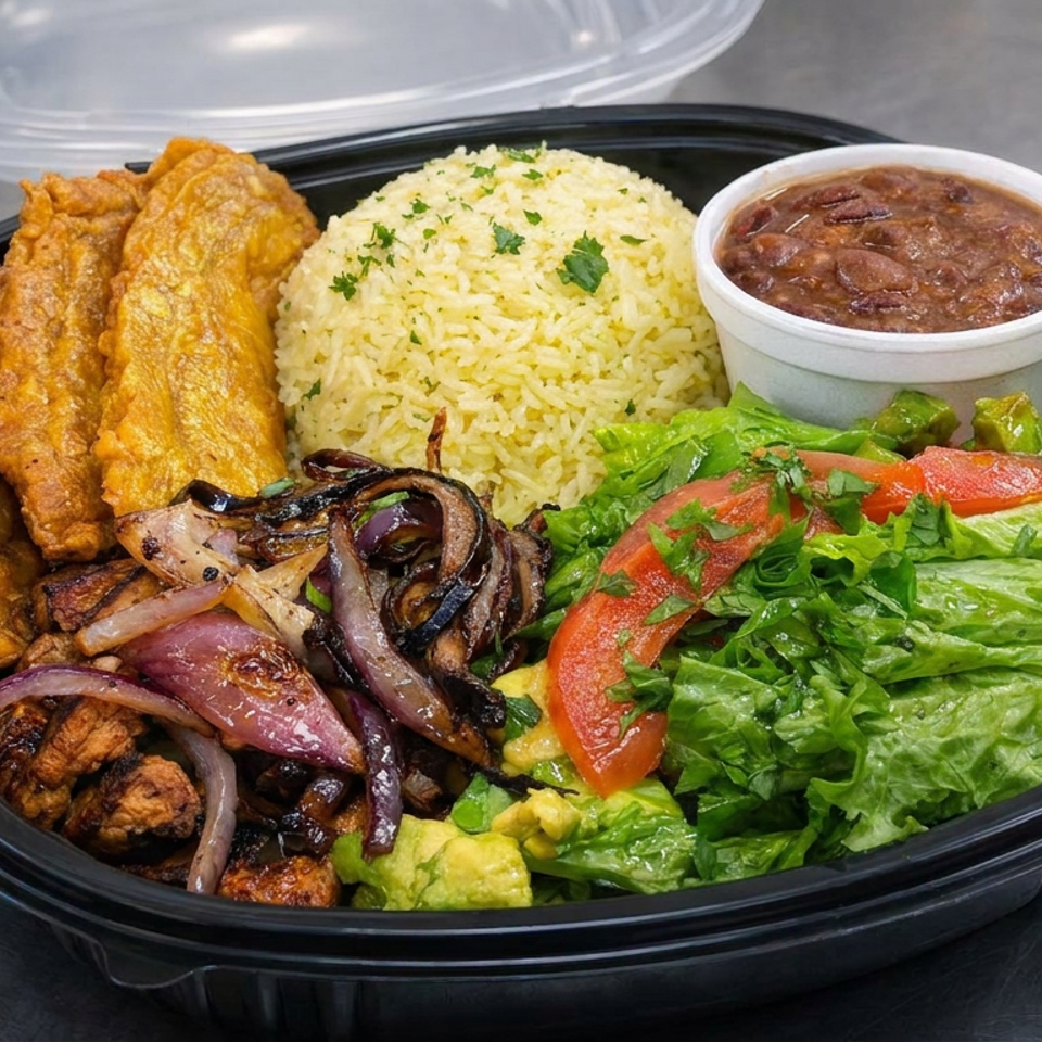 Takeout platter with fried plantains, seasoned rice, beans, grilled onions, avocado, and lettuce tomato salad.